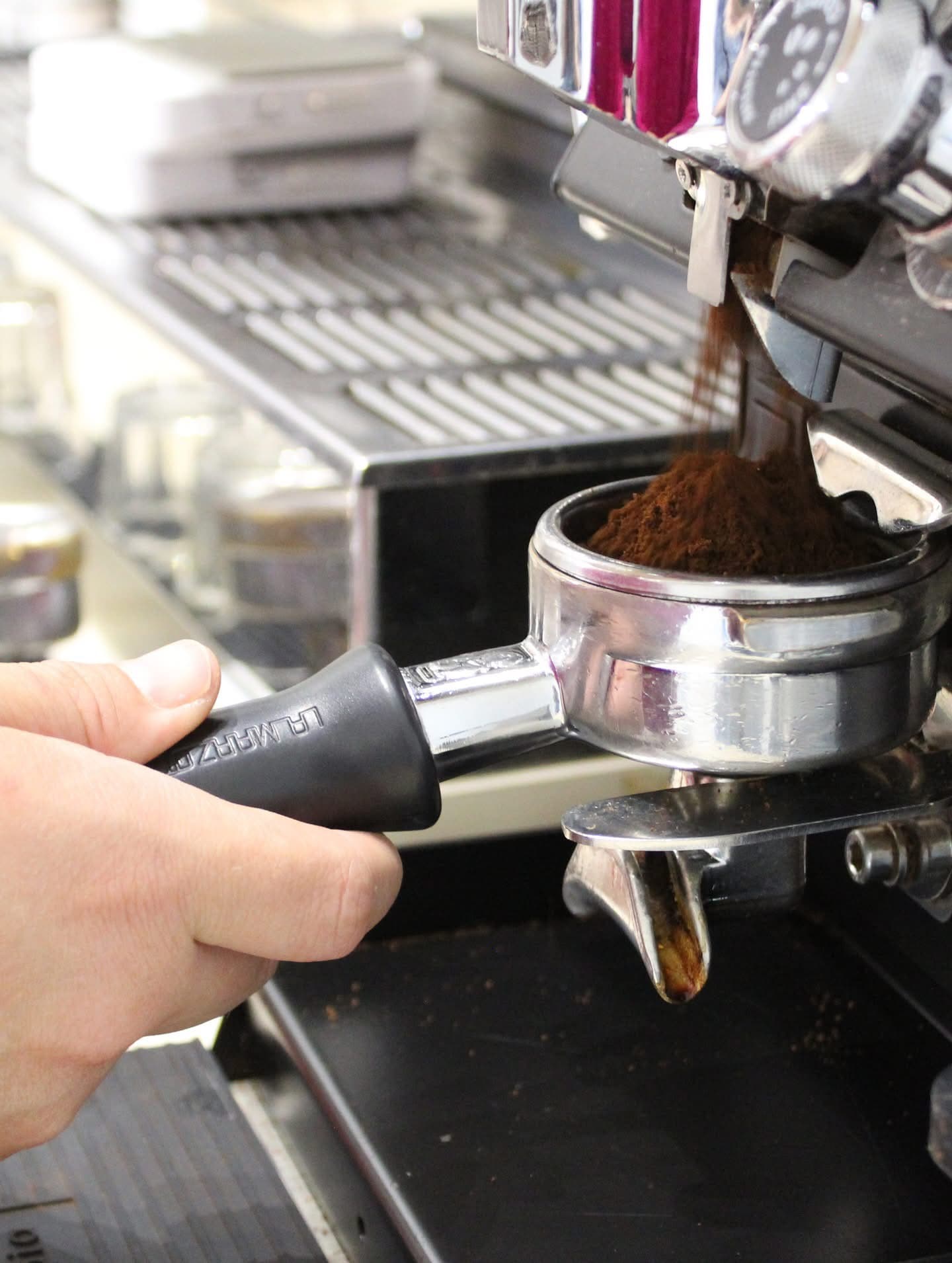 Barista pulling a fresh espresso shot on the La Marzocco machine at Kaleidoscope Cafe